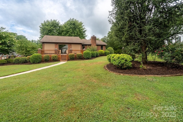 614 Azalea Ln, China Grove, NC 28023 - ranch-style house with a chimney, a front lawn, a deck, and brick siding