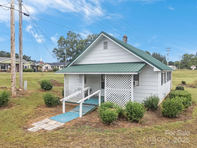 10 Manus Chapel Rd, Mill Spring, NC 28756 - view of front facade with a front yard, a chimney, a metal roof, and covered porch