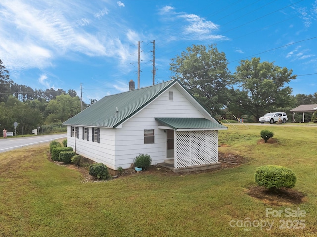 10 Manus Chapel Rd, Mill Spring, NC 28756 - back of property featuring a lawn and a metal roof