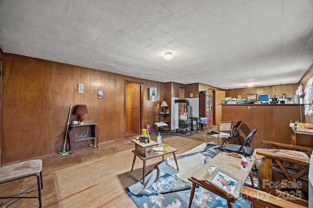 10 Manus Chapel Rd, Mill Spring, NC 28756 - living room with a wood stove, light wood-style flooring, and wooden walls