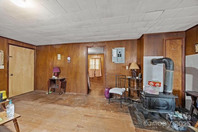 10 Manus Chapel Rd, Mill Spring, NC 28756 - living room featuring hardwood / wood-style floors, wooden walls, electric panel, and a wood stove