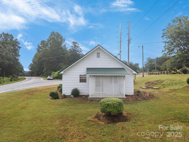10 Manus Chapel Rd, Mill Spring, NC 28756 - view of side of home with a lawn and a metal roof