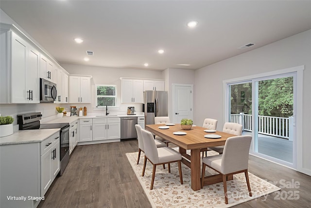 1951 32nd St NE Unit 1, Hickory, NC 28601 - kitchen with appliances with stainless steel finishes, wood finished floors, white cabinets, and recessed lighting