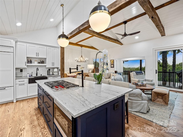 80 Raven Rock Vis, Lake Toxaway, NC 28747 - kitchen with stainless steel gas cooktop, light wood-style flooring, white cabinetry, recessed lighting, and a wood ceiling with exposed beams