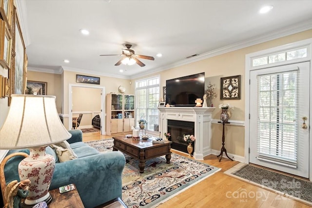 1511 Elkhart Cir, Gastonia, NC 28054 - living area featuring a ceiling fan, wood finished floors, a glass covered fireplace, recessed lighting, and crown molding