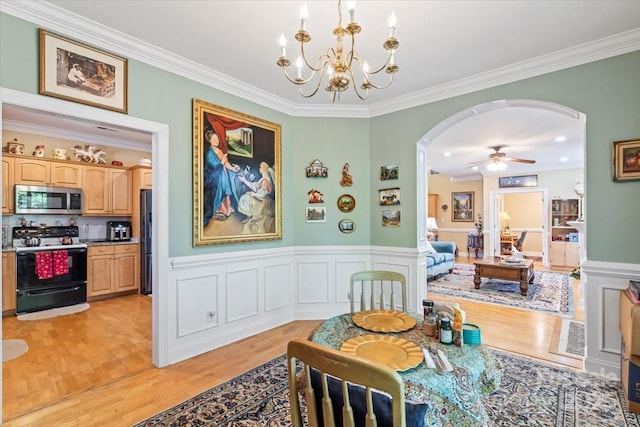 1511 Elkhart Cir, Gastonia, NC 28054 - dining area with arched walkways, crown molding, a chandelier, light wood finished floors, and a wainscoted wall