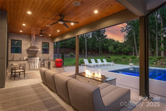 8403 Sarsfield Ct, Waxhaw, NC 28173 - fenced backyard featuring an outdoor kitchen, a patio area, an outdoor living space with a fire pit, and a ceiling fan