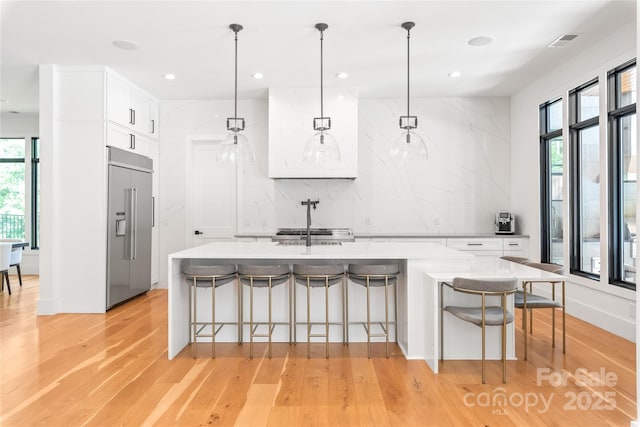 8403 Sarsfield Ct, Waxhaw, NC 28173 - kitchen featuring built in refrigerator, plenty of natural light, light countertops, light wood finished floors, and recessed lighting