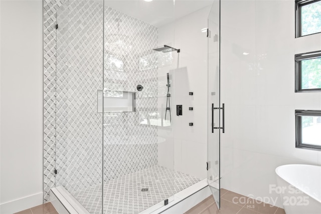 8403 Sarsfield Ct, Waxhaw, NC 28173 - bathroom with a soaking tub, tile patterned flooring, and a stall shower