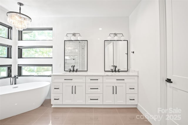8403 Sarsfield Ct, Waxhaw, NC 28173 - full bathroom with double vanity, a freestanding tub, tile patterned floors, and a chandelier