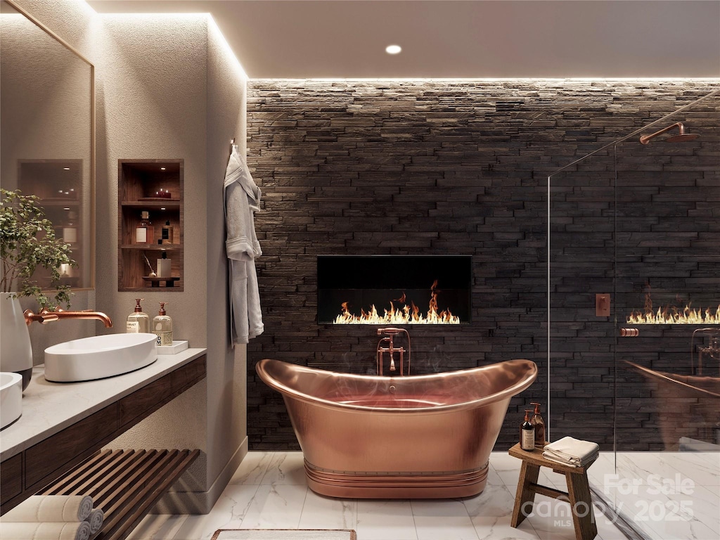 227 7th Ave W Unit 322, Hendersonville, NC 28791 - bathroom with a soaking tub, marble look tile flooring, a lit fireplace, double vanity, and walk in shower