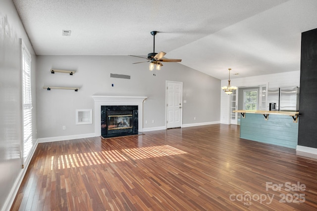 1012 Thorncrest Dr, Fletcher, NC 28732 - unfurnished living room featuring ceiling fan, a fireplace, dark wood-style floors, a chandelier, and vaulted ceiling