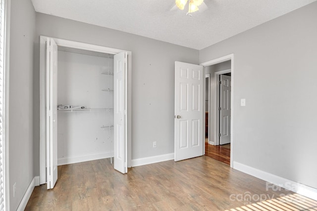 1012 Thorncrest Dr, Fletcher, NC 28732 - unfurnished bedroom with wood finished floors, a closet, ceiling fan, and a textured ceiling