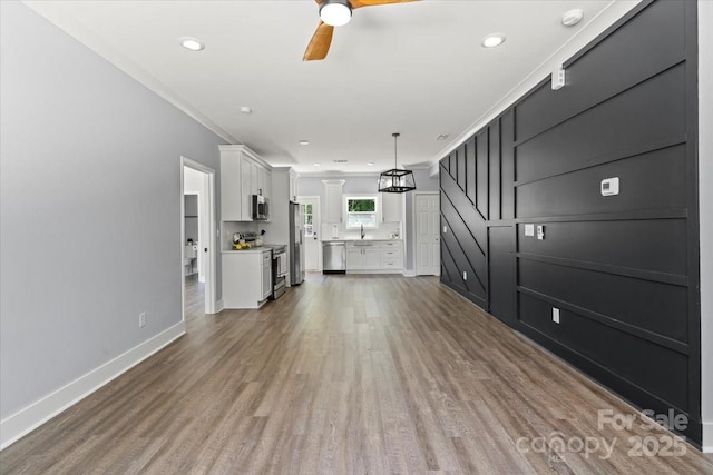 100 Boyette Dr Unit A, Albemarle, NC 28001 - unfurnished living room with light wood finished floors, a ceiling fan, crown molding, and recessed lighting