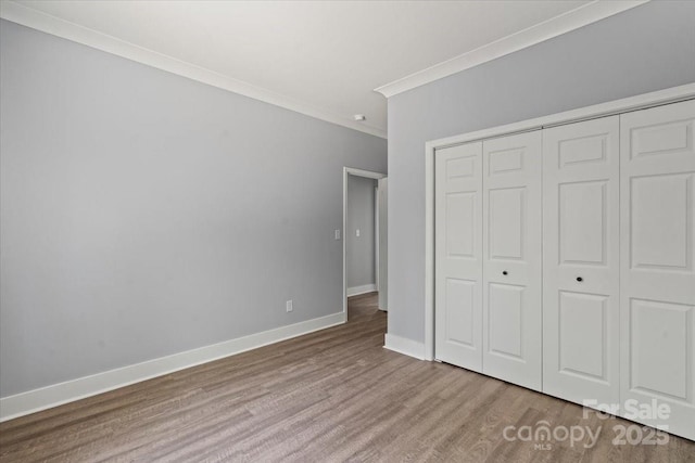 100 Boyette Dr Unit A, Albemarle, NC 28001 - unfurnished bedroom with crown molding, wood finished floors, and a closet