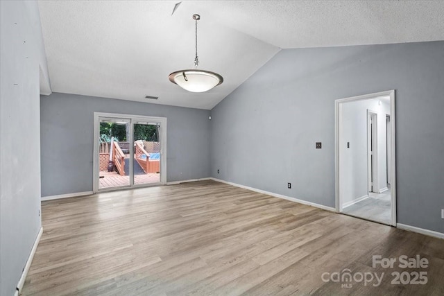 6500 Peacehaven Dr, Charlotte, NC 28214 - spare room with wood finished floors, lofted ceiling, french doors, and a textured ceiling