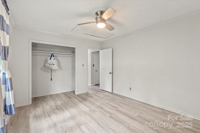 6500 Peacehaven Dr, Charlotte, NC 28214 - unfurnished bedroom featuring light wood-type flooring, a closet, a textured ceiling, and a ceiling fan