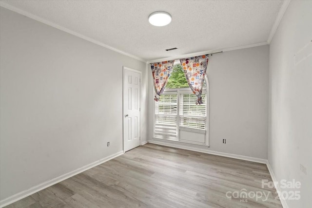 6500 Peacehaven Dr, Charlotte, NC 28214 - spare room featuring a textured ceiling, crown molding, and light wood finished floors
