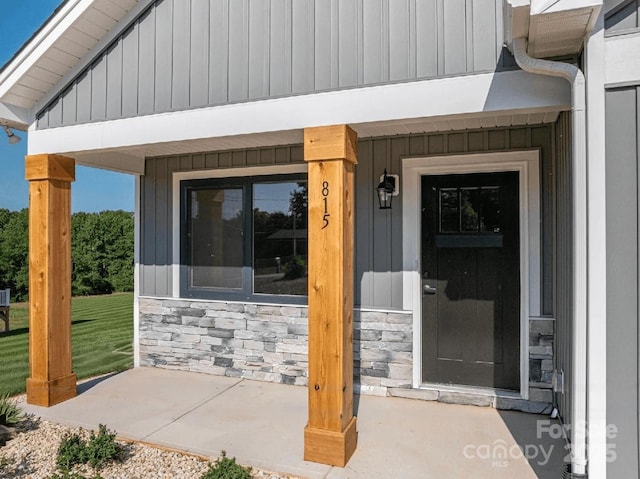 815 32nd St NE Unit 3, Conover, NC 28613 - entrance to property featuring stone siding, covered porch, board and batten siding, and a lawn