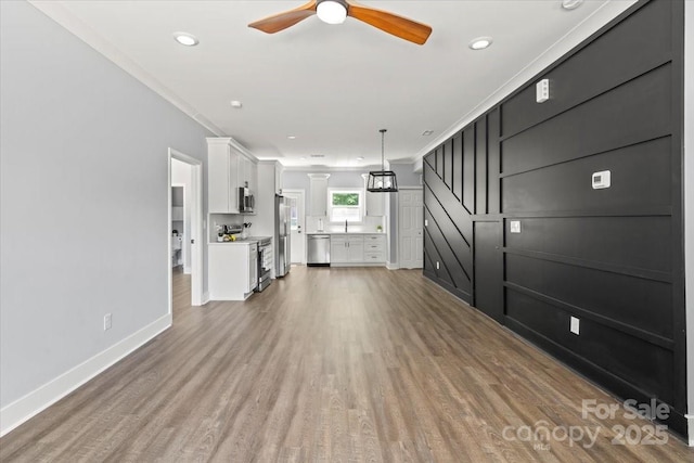 100 Boyette Dr Unit B, Albemarle, NC 28001 - unfurnished living room featuring ceiling fan, wood finished floors, ornamental molding, and recessed lighting
