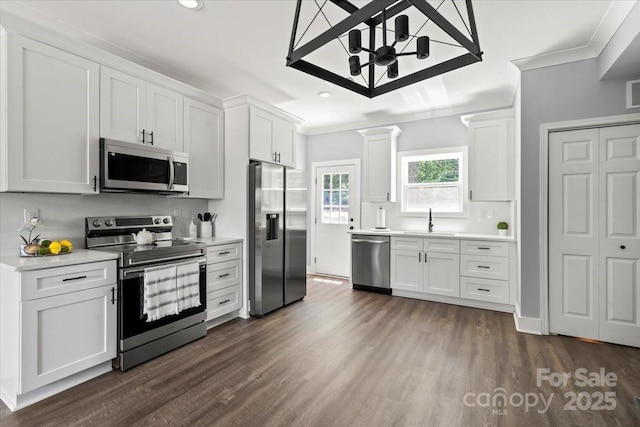100 Boyette Dr Unit B, Albemarle, NC 28001 - kitchen featuring stainless steel appliances, ornamental molding, light countertops, dark wood-style flooring, and white cabinetry