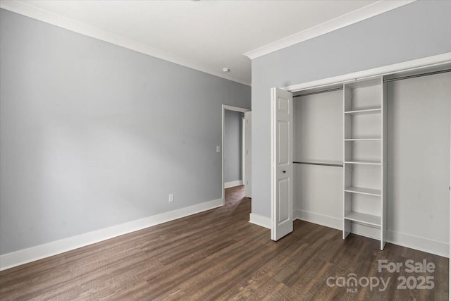 100 Boyette Dr Unit B, Albemarle, NC 28001 - unfurnished bedroom with dark wood-type flooring, a closet, and crown molding