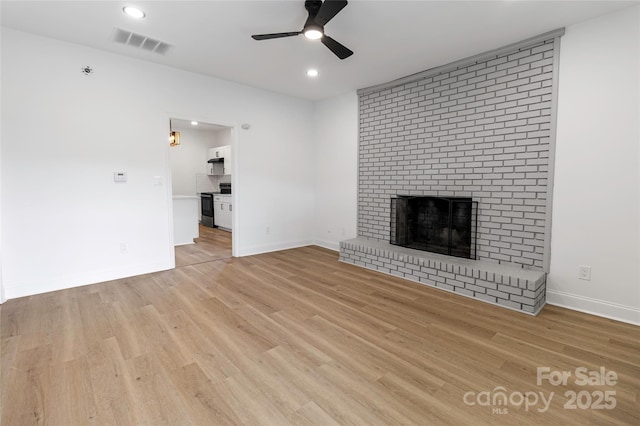 501 N Apple St Unit 103, Gastonia, NC 28054 - unfurnished living room featuring a ceiling fan, a fireplace, light wood-style flooring, and recessed lighting