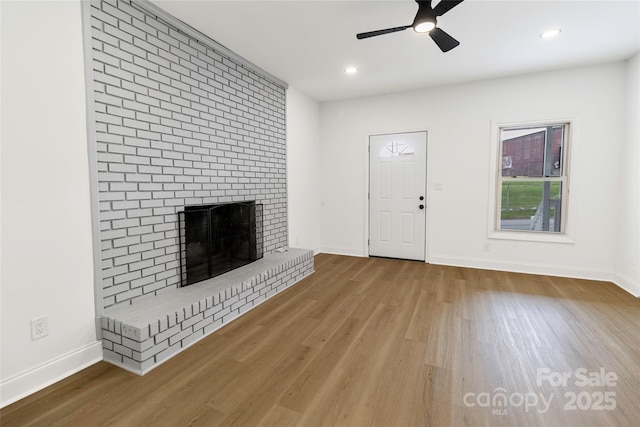 501 N Apple St Unit 103, Gastonia, NC 28054 - unfurnished living room with a fireplace, wood finished floors, a ceiling fan, and recessed lighting