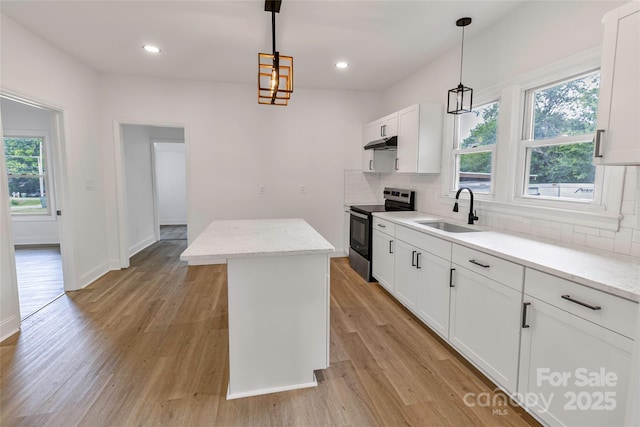 501 N Apple St Unit 103, Gastonia, NC 28054 - kitchen with stainless steel range with electric stovetop, under cabinet range hood, a kitchen island, backsplash, and recessed lighting