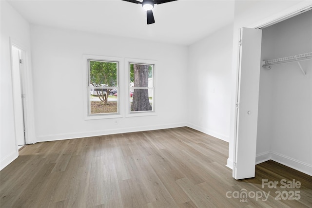 501 N Apple St Unit 103, Gastonia, NC 28054 - unfurnished bedroom with wood finished floors, a closet, and a ceiling fan
