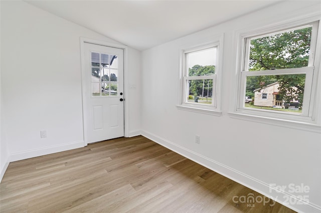 501 N Apple St Unit 103, Gastonia, NC 28054 - empty room with vaulted ceiling, healthy amount of natural light, and light wood-style flooring