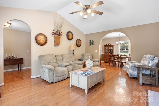 123 Clearwater Dr, Morganton, NC 28655 - living area featuring arched walkways, a ceiling fan, light wood-style floors, lofted ceiling, and a chandelier