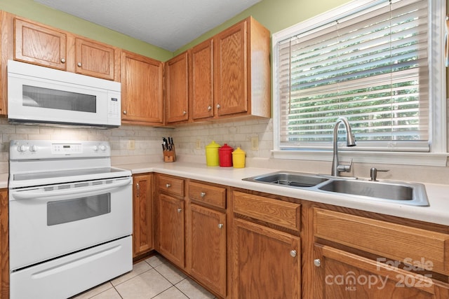 123 Clearwater Dr, Morganton, NC 28655 - kitchen featuring white appliances, light countertops, light tile patterned floors, and tasteful backsplash