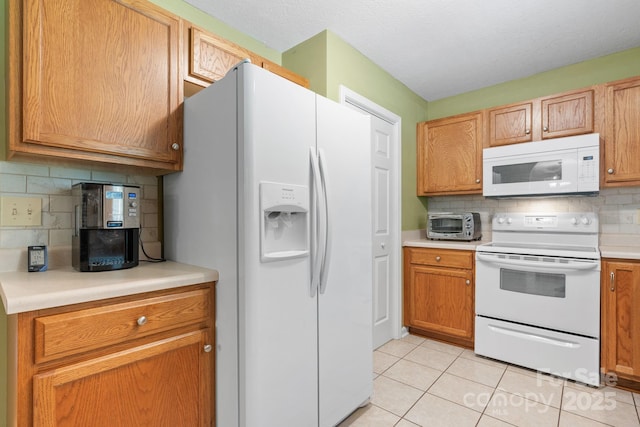 123 Clearwater Dr, Morganton, NC 28655 - kitchen with white appliances, decorative backsplash, light tile patterned floors, and light countertops