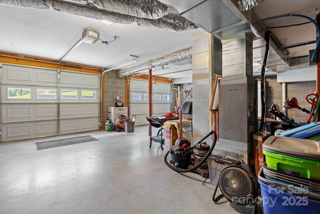 123 Clearwater Dr, Morganton, NC 28655 - garage featuring a garage door opener and concrete block wall