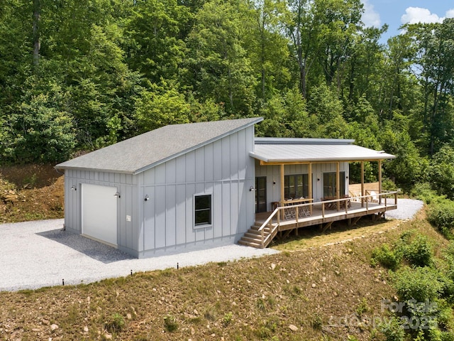 511 Emerald Mine Rd, Spruce Pine, NC 28777 - view of front of property featuring a shingled roof, board and batten siding, driveway, an attached garage, and covered porch