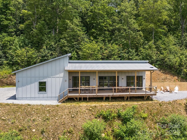 511 Emerald Mine Rd, Spruce Pine, NC 28777 - view of front facade with board and batten siding, a wooded view, and a metal roof