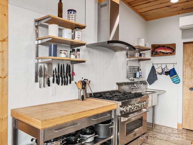 511 Emerald Mine Rd, Spruce Pine, NC 28777 - kitchen with high end stainless steel range, island exhaust hood, an AC wall unit, open shelves, and wood ceiling