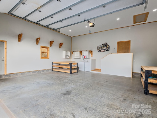 511 Emerald Mine Rd, Spruce Pine, NC 28777 - garage featuring a workshop area, independent washer and dryer, a garage door opener, and recessed lighting