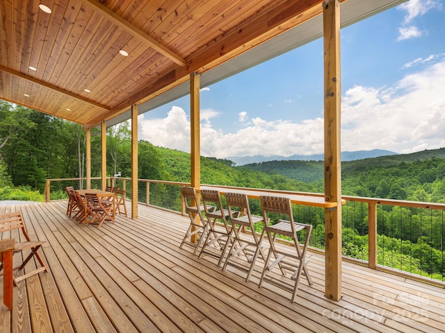 511 Emerald Mine Rd, Spruce Pine, NC 28777 - deck with outdoor dining area, a view of trees, and a mountain view