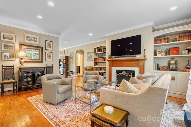 1902 4th Street Ct NW, Hickory, NC 28601 - living room with arched walkways, recessed lighting, light wood finished floors, a fireplace, and ornamental molding
