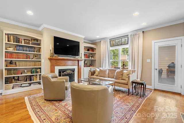 1902 4th Street Ct NW, Hickory, NC 28601 - living area with crown molding, a fireplace, light wood-style floors, recessed lighting, and built in shelves