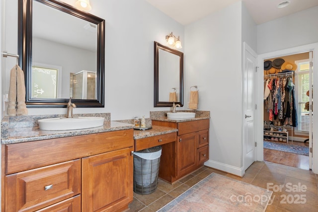 1902 4th Street Ct NW, Hickory, NC 28601 - full bathroom with tile patterned floors, double vanity, a spacious closet, and an enclosed shower