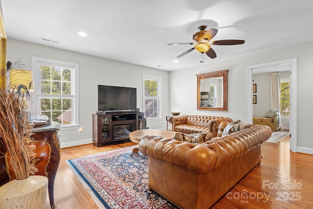 1902 4th Street Ct NW, Hickory, NC 28601 - living area with a ceiling fan, light wood finished floors, a glass covered fireplace, and recessed lighting