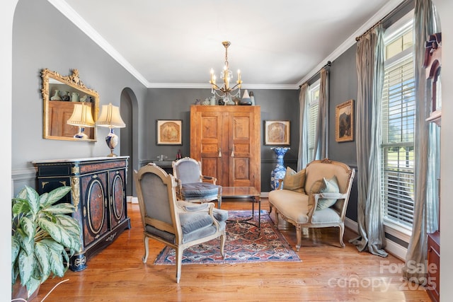 1902 4th Street Ct NW, Hickory, NC 28601 - living area featuring a chandelier, healthy amount of natural light, arched walkways, ornamental molding, and wood finished floors