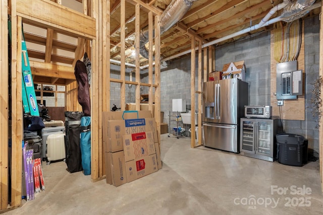 1902 4th Street Ct NW, Hickory, NC 28601 - unfinished below grade area featuring stainless steel fridge, beverage cooler, electric panel, and concrete block wall