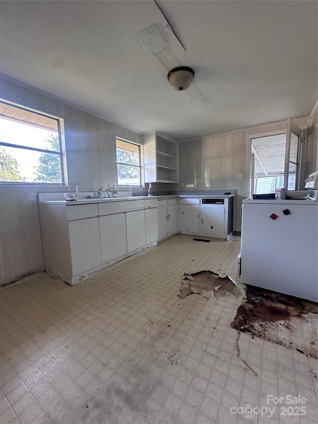 508 S Ave SW, Valdese, NC 28680 - kitchen with light flooring, white cabinets, and open shelves