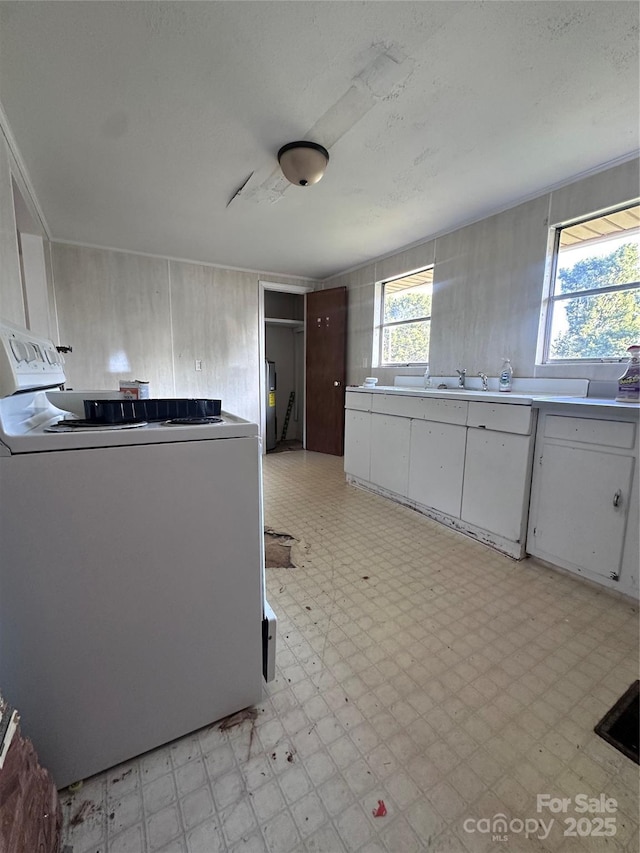 508 S Ave SW, Valdese, NC 28680 - kitchen featuring range, light flooring, white cabinetry, and light countertops