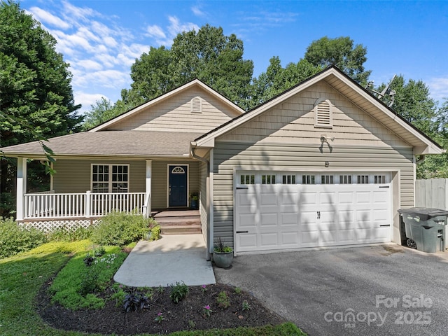 690 Mountain Rd, Hendersonville, NC 28791 - ranch-style house featuring a porch, a garage, driveway, and roof with shingles