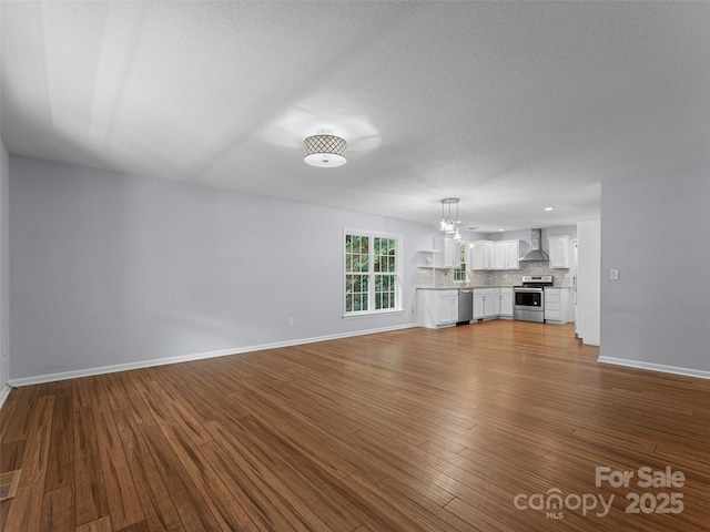 690 Mountain Rd, Hendersonville, NC 28791 - unfurnished living room with dark wood-type flooring, a textured ceiling, and a chandelier